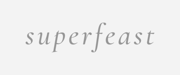 The word "superfeast" written in light gray cursive font.