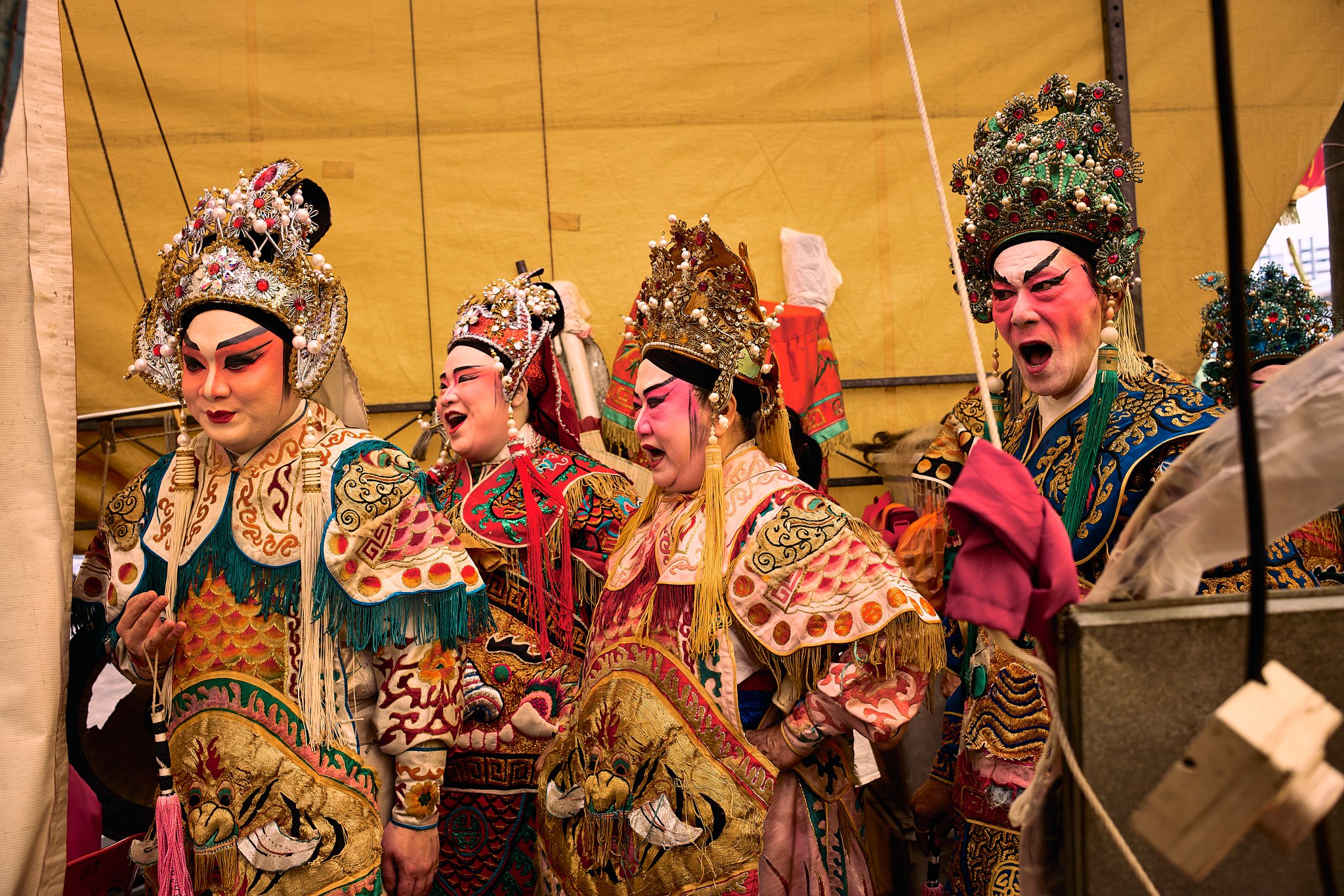 Chinese opera performers backstage at a Singapore temple, captured moments before the performance—where costume, ritual, and anticipation converge.