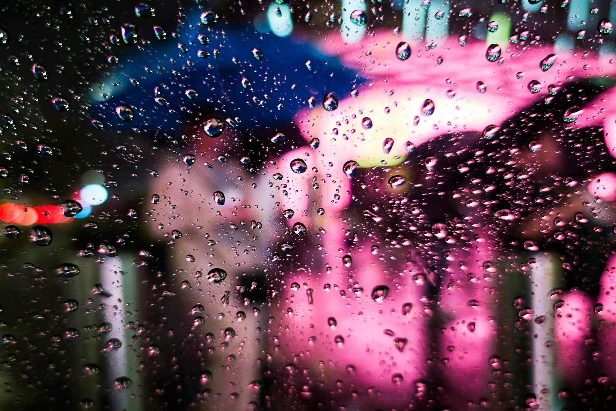 Taken on Orchard Road during a heavy storm, this image observes the city through rain-streaked glass, capturing light and colour as they blur into an abstract urban scene.