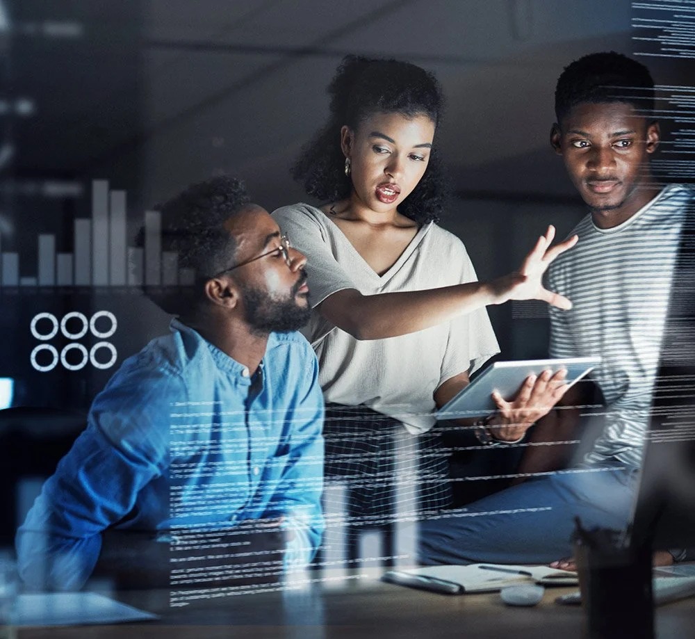 Three professionals in a modern office discussing human resources and health & safety data and charts on a transparent digital display.