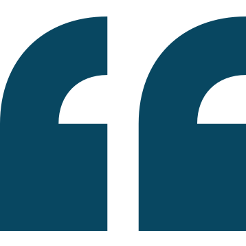 Close-up of a large blue quotation mark symbol.