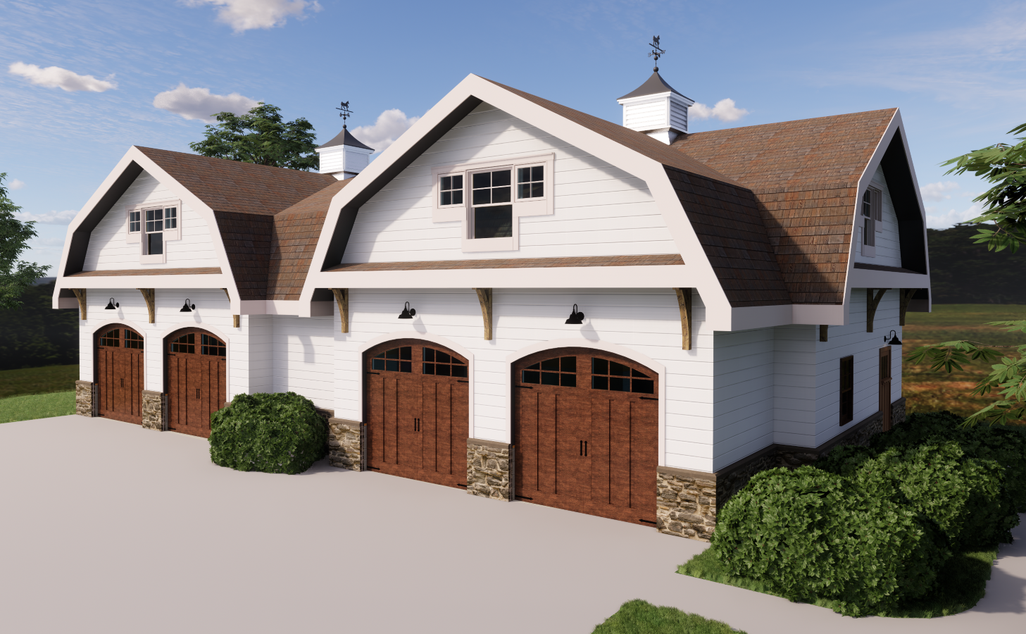 A modern barn-style building with three garage doors made of wood, white siding, stone accents at the base, and a sloped roof with two cupolas and weather vanes, surrounded by greenery and a blue sky with clouds.