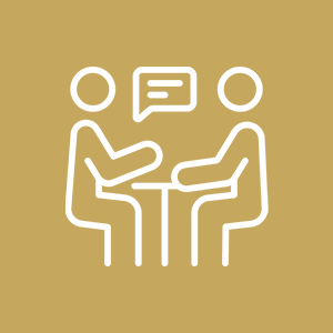 Two people sitting at a table having a conversation, with speech bubble between them, outlined in white on a gold background.