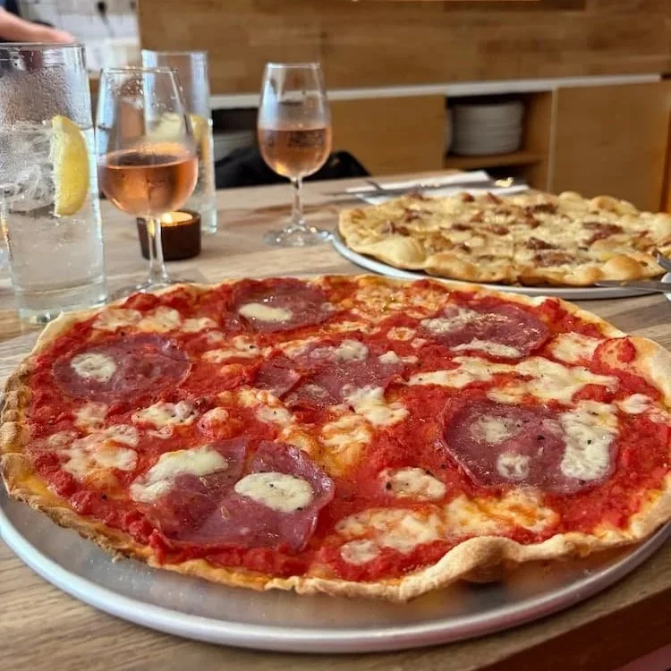 Pizzas at Bar Caput, Stockput, with glasses of rose in background