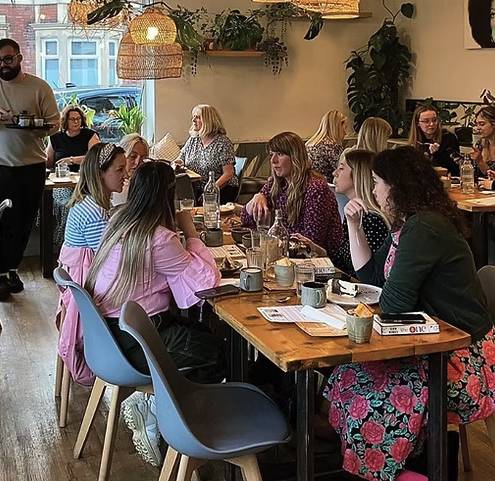 Group of ladies gathering in a cafe for Book & Pudding Club