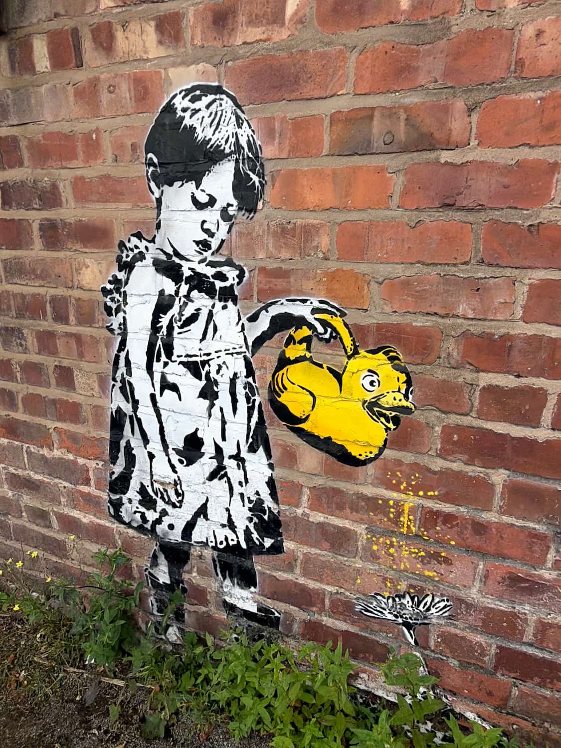 Mural of child holding a duck watering can by street artist 'Mr Eggs'