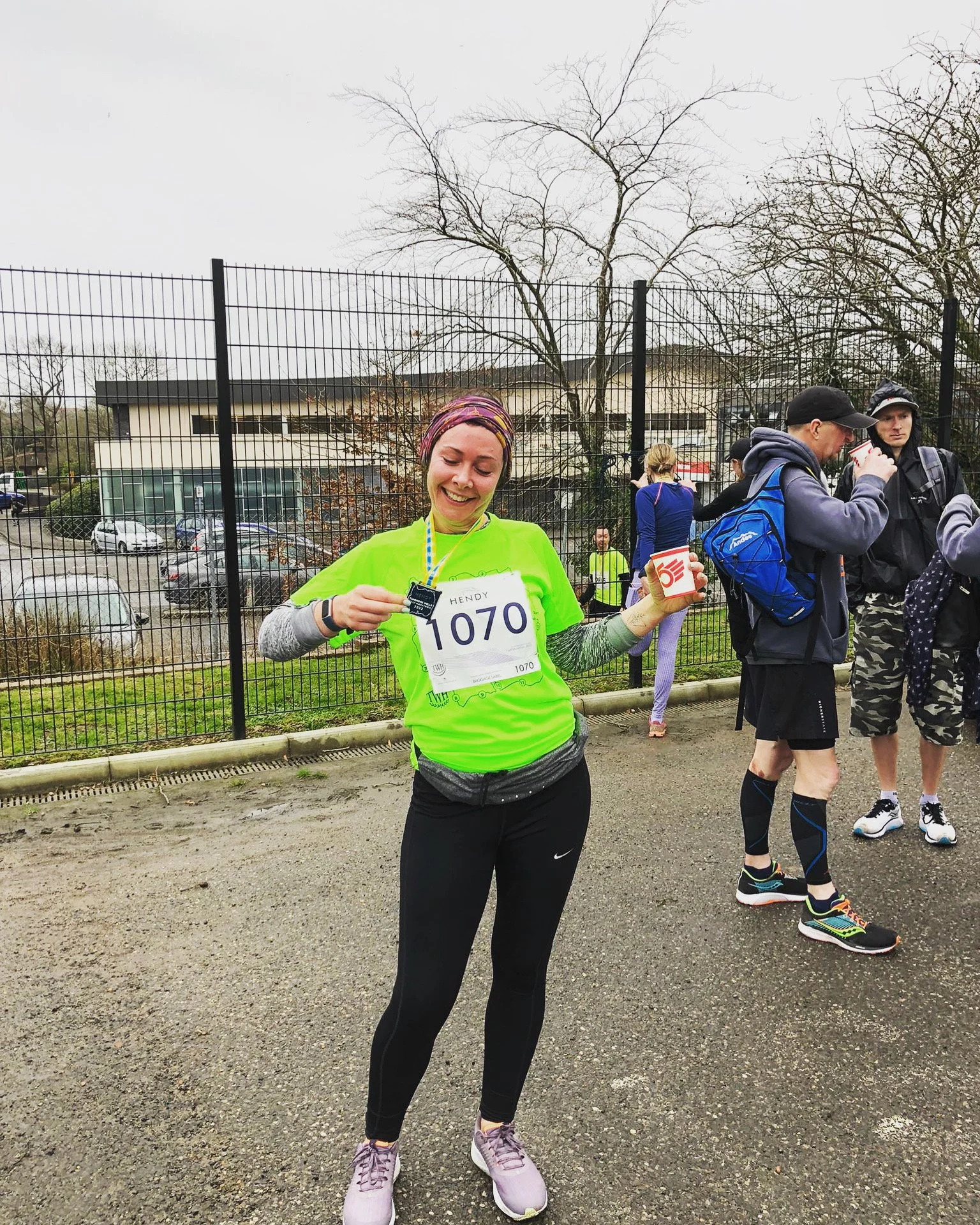 Girl holding a medal after running first half marathon