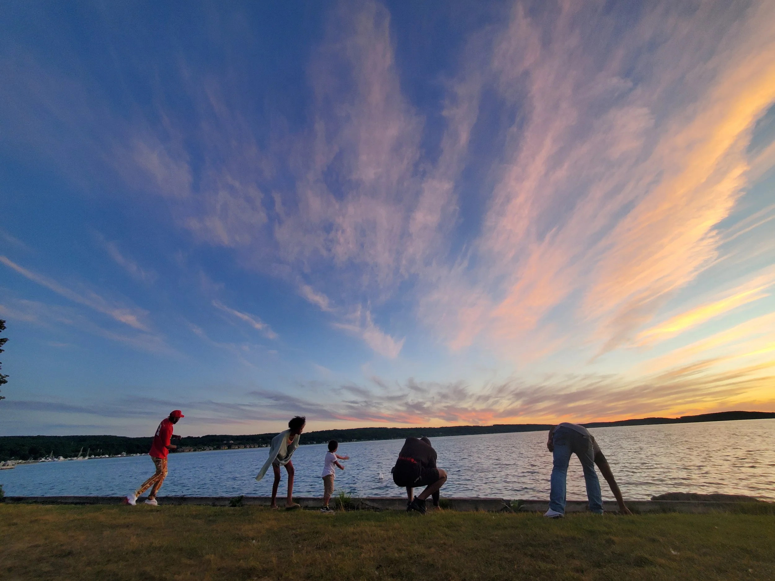 Family skipping rocks Lake Charlevoix