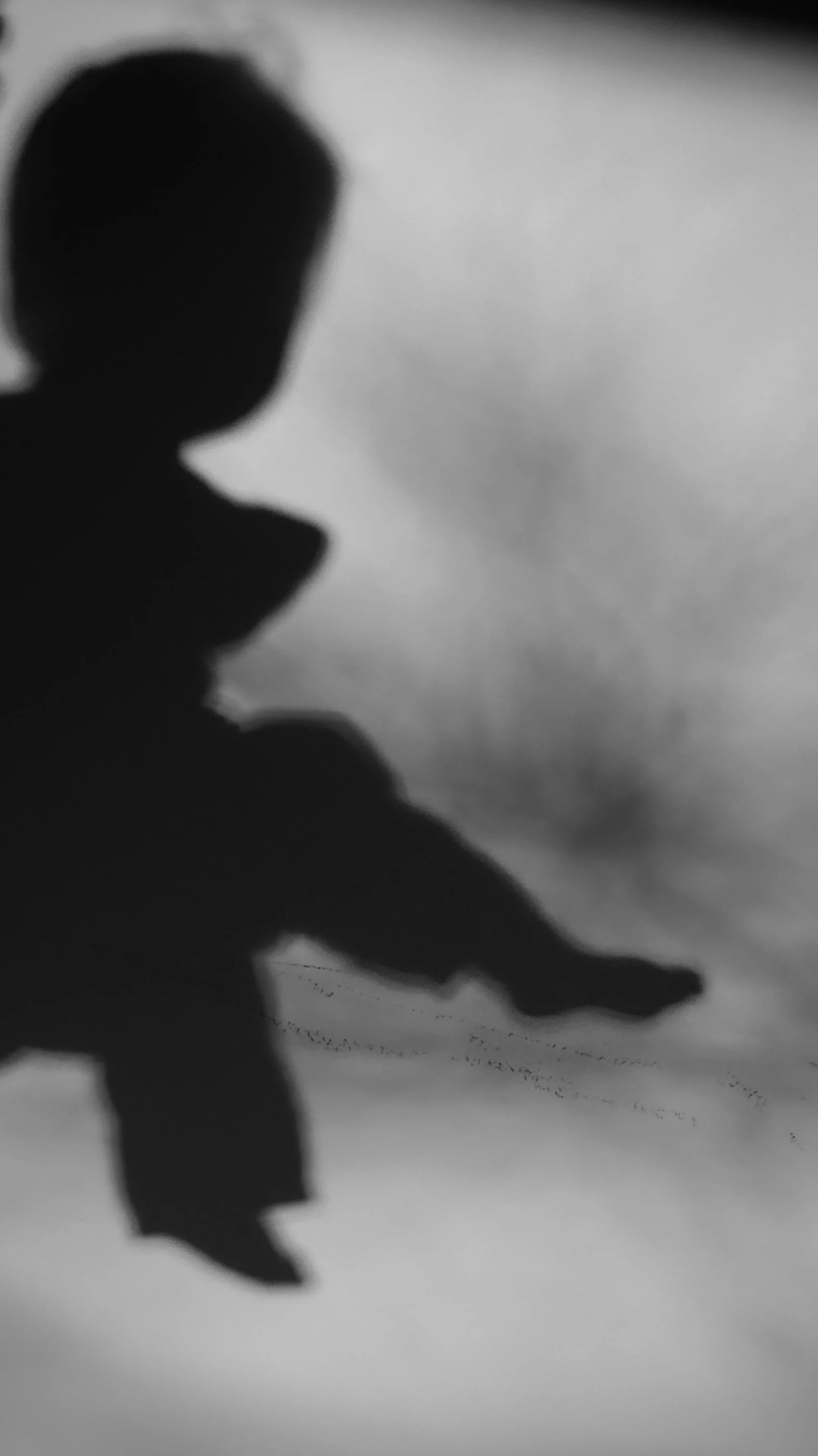 Silhouette of a person against a cloudy sky