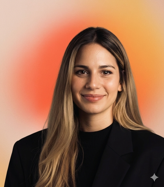 A woman with long blonde hair wearing a black blazer, smiling against a colorful gradient background.