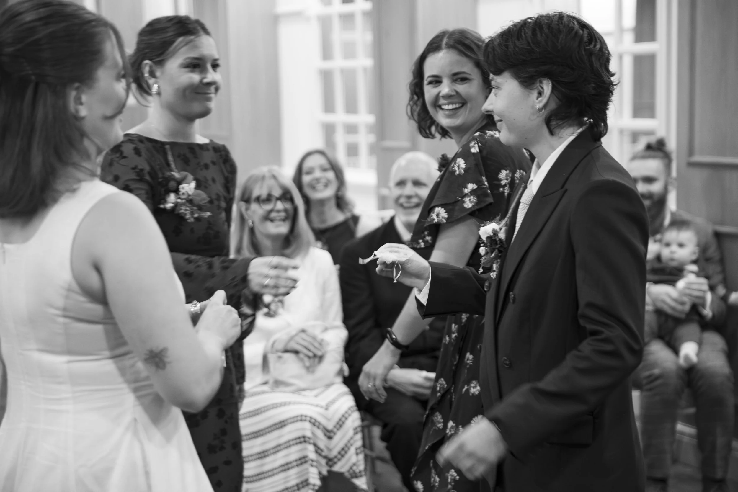 A group of women exchanging wedding rings at a wedding ceremony.