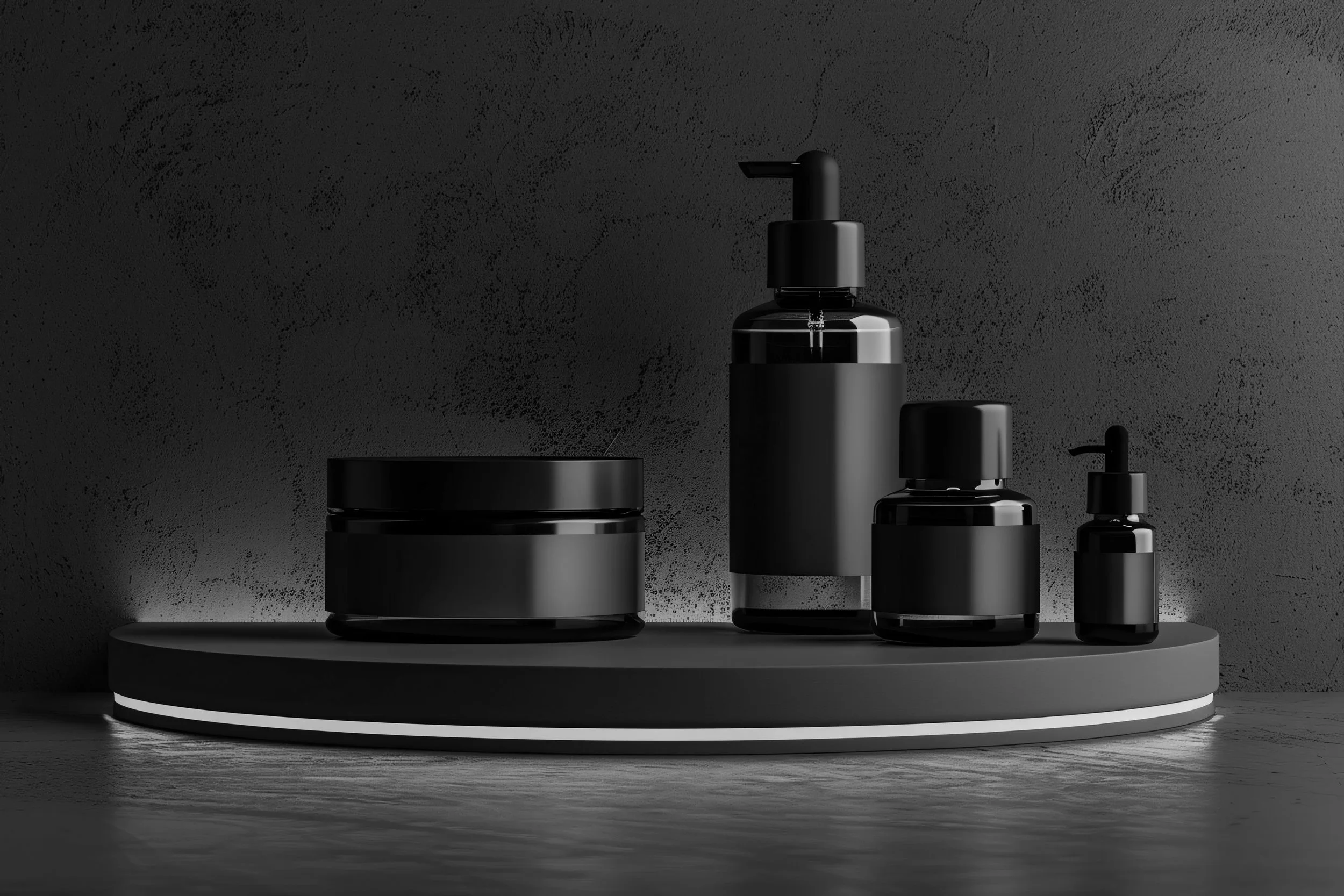 Black skincare or cosmetic bottles and jars on a round platform against a textured dark wall.