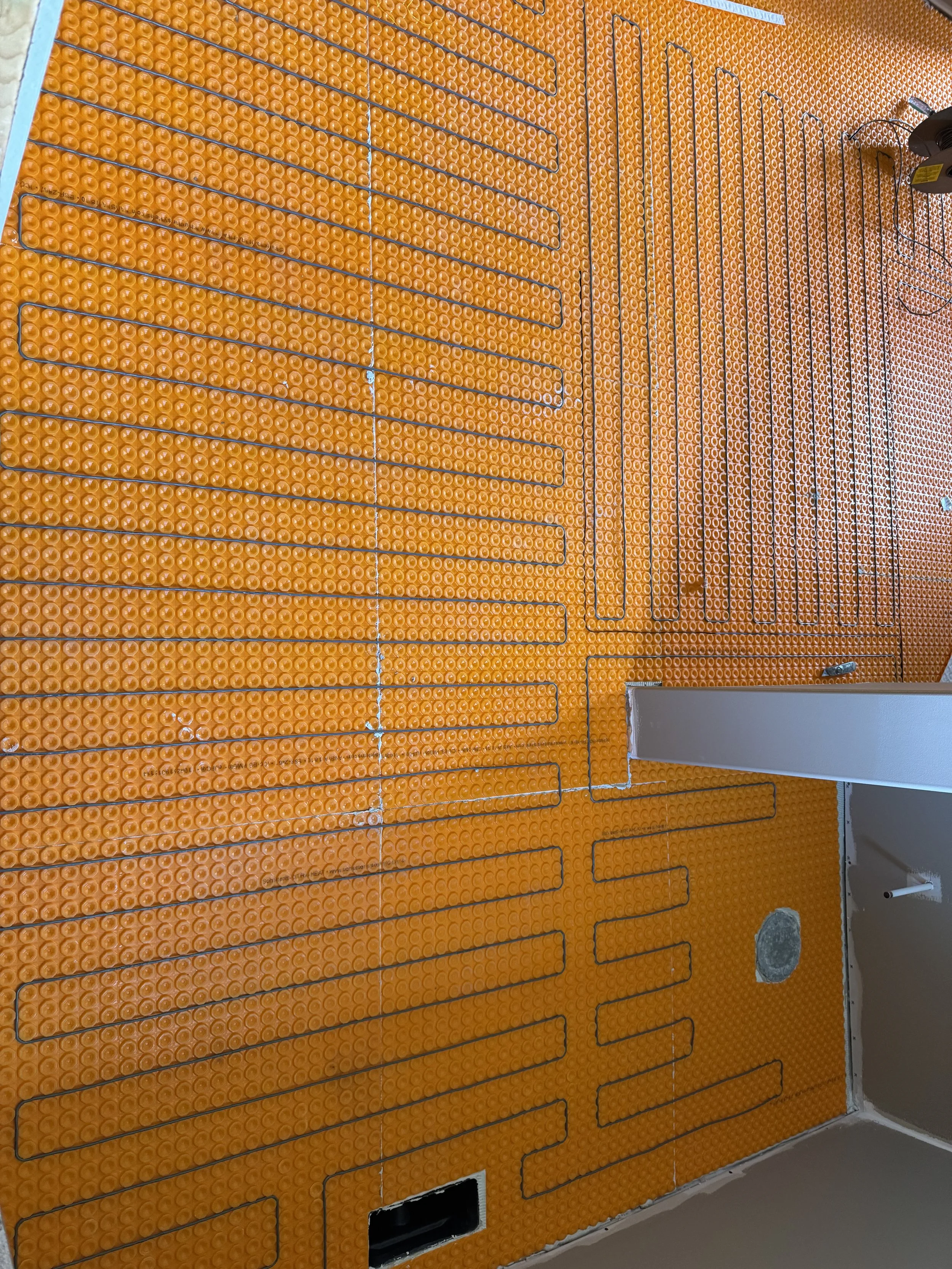 Underfloor heating pipes installed on a bright orange insulation panel in a room under construction.


Installed near Dayton Ohio 