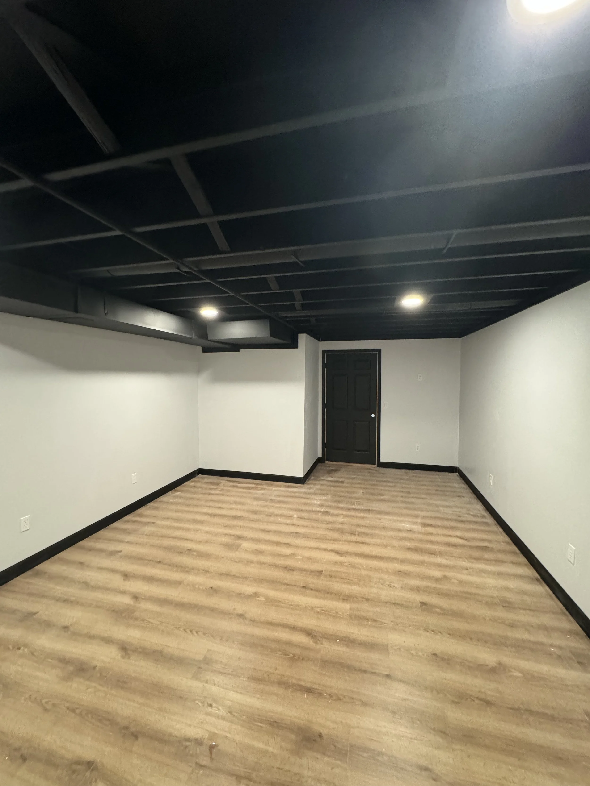 Empty room with black ceiling, white walls, and light wood flooring.

Installed near dayton ohio