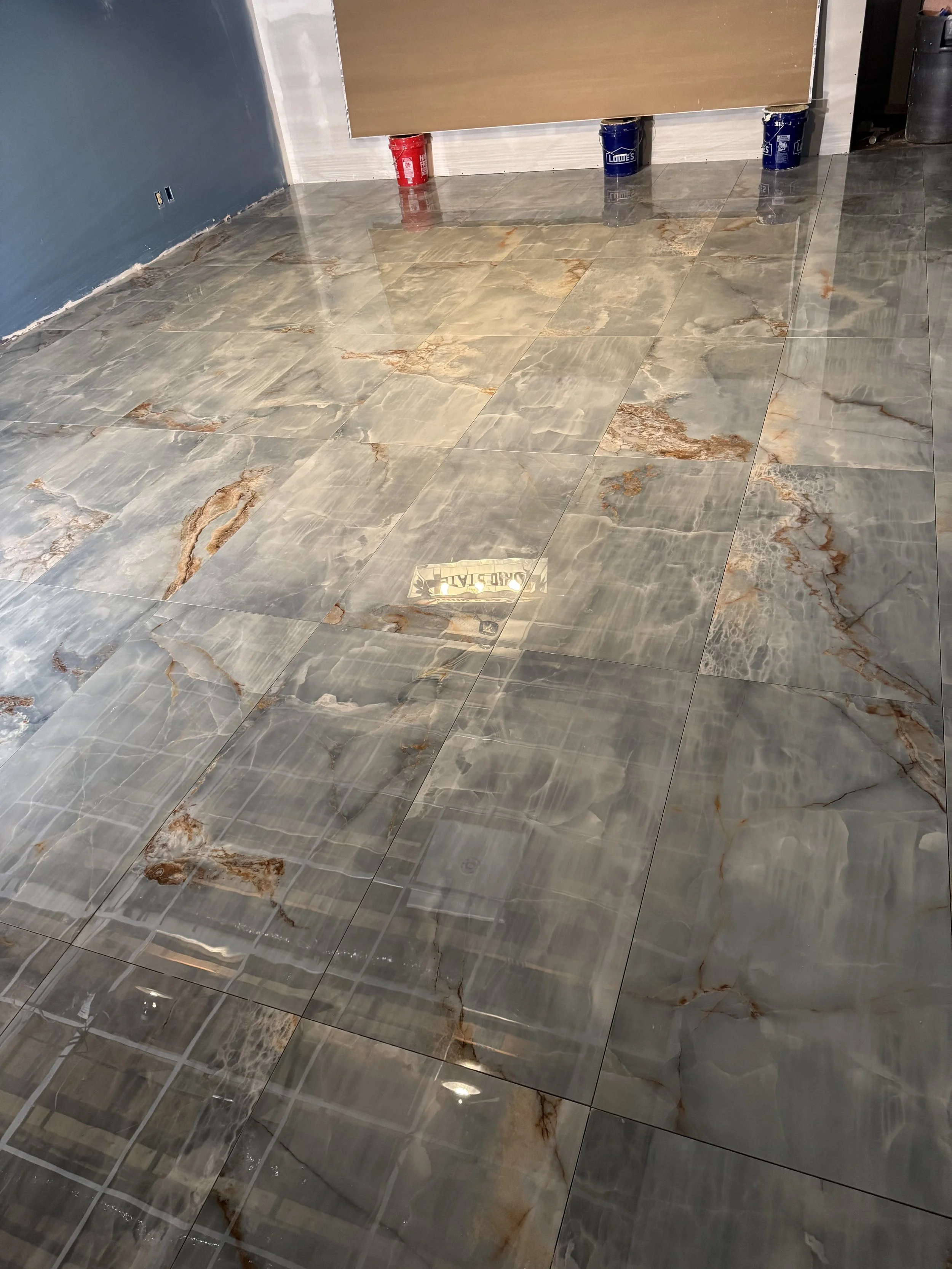 Under construction room with marble flooring, blue wall, and construction materials like paint cans in the background.



Installed in west Alexandria Ohio 