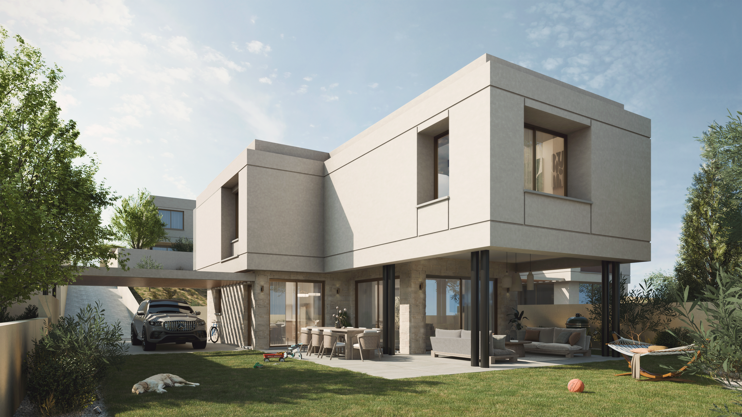 Modern two-story house with outdoor patio and lawn, car parked under carport, dog lying on grass, kids' toys, hammock, and trees in the yard.