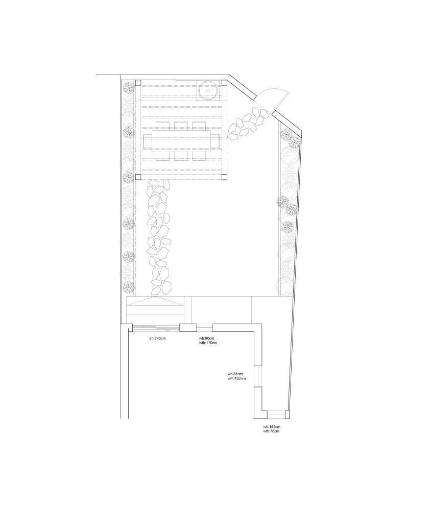 A detailed architectural plan of a backyard garden and patio area, including a dining table with chairs, a pathway lined with rocks, and a small outdoor seating area with a door leading into a building.