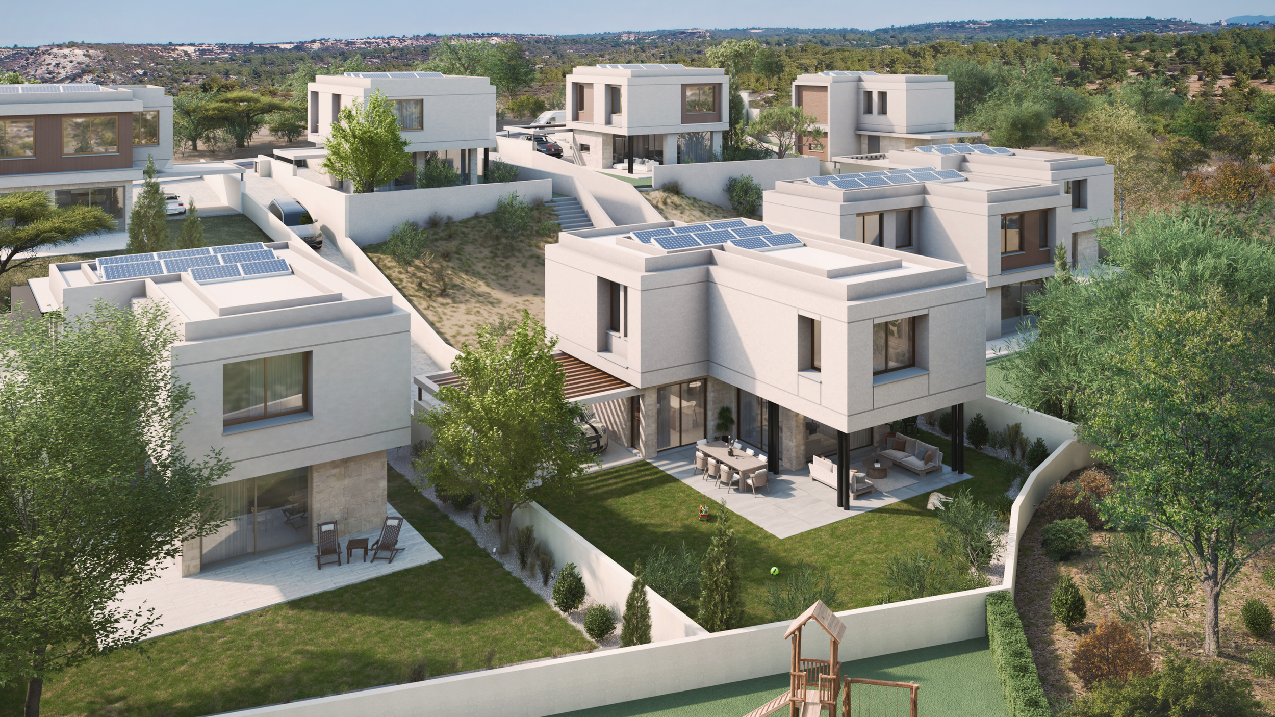 Modern residential houses on a hillside with rooms featuring solar panels on the roofs, outdoor seating, green lawns, trees, and a playground area.