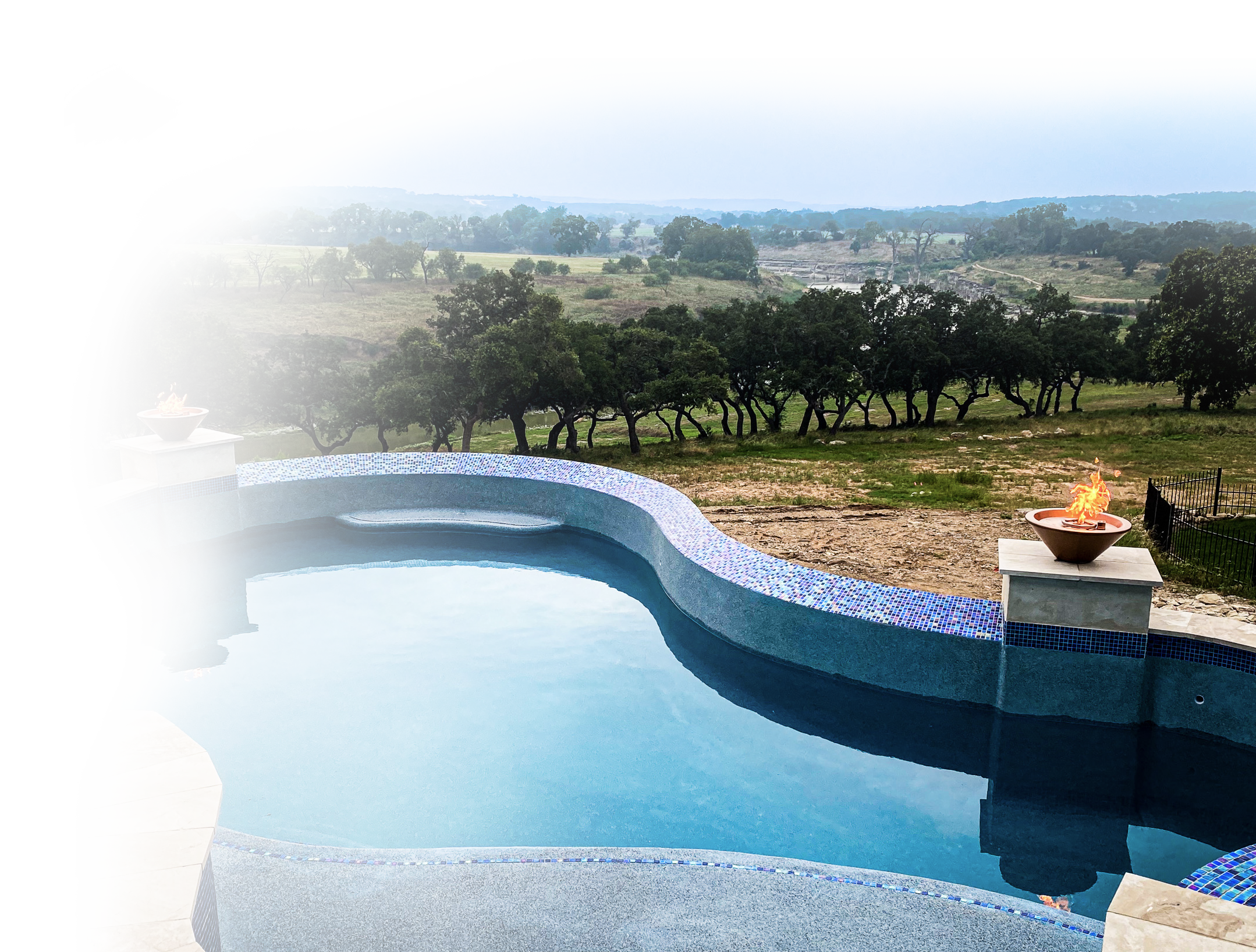 Luxury custom pool with PebbleTec interior and fire features in the Texas Hill Country by Christopher Ashley Pools