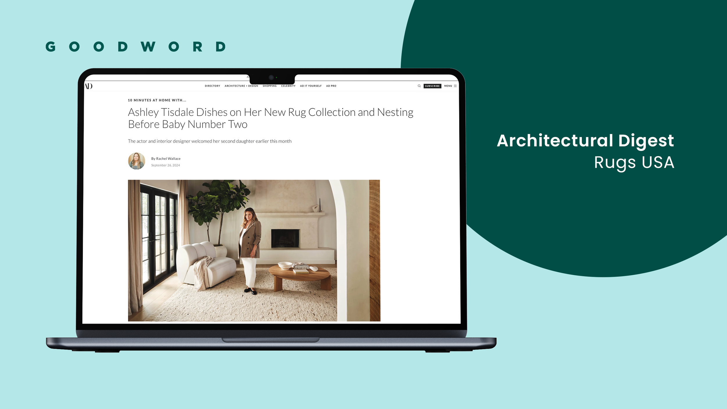 A laptop displaying an online magazine article about interior design, featuring a woman standing in a living room with a white couch, a large plant, and a fireplace, on a background with the text 'Architectural Digest Rugs USA' on a large dark green 
