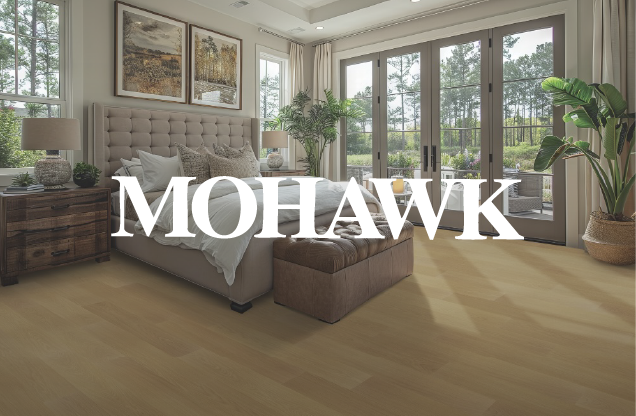 Bright bedroom with large windows, a beige bed with pillows, wooden nightstands, potted plants, and minimalist decor.