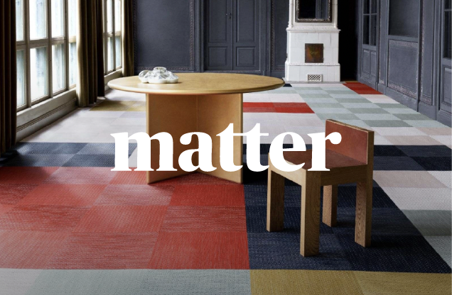 A room with a large round wooden table, a small wooden chair, and multicolored carpet tiles, with the word 'matter' overlaid in white text.