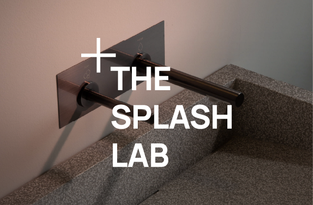 Interior of a modern shower with a wall-mounted grab bar and the words '+ THE SPLASH LAB' in large white text.