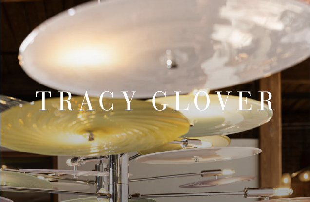 Close-up of a metal sculpture of overlapping circular disks with the text 'Tracy Glover' in the center.