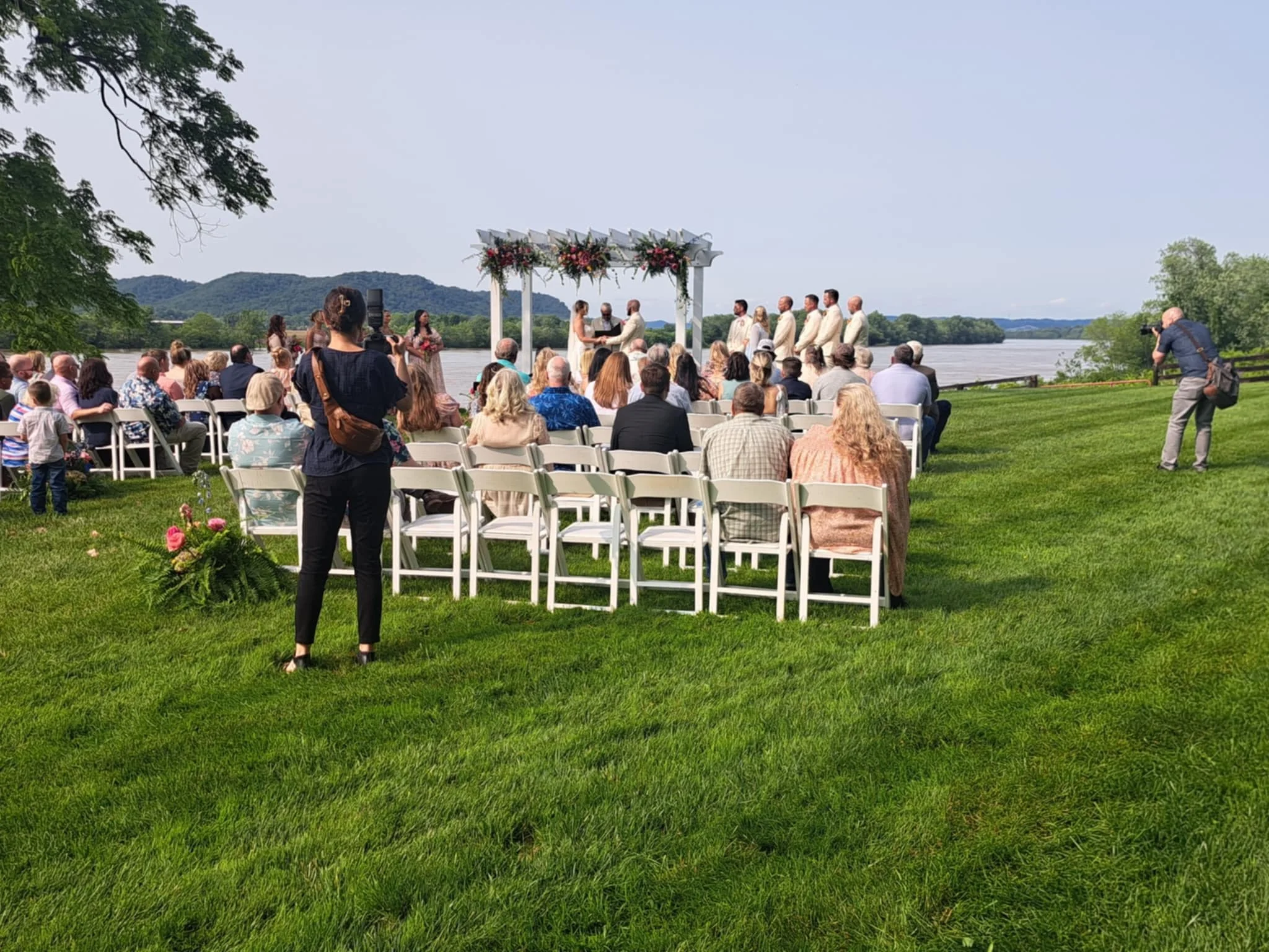 Kenzie, of Kenzie Riley Photography from Kentucky at Red Gate Farm and Vineyard, Quincy, KY capturing the ceremony by the river.