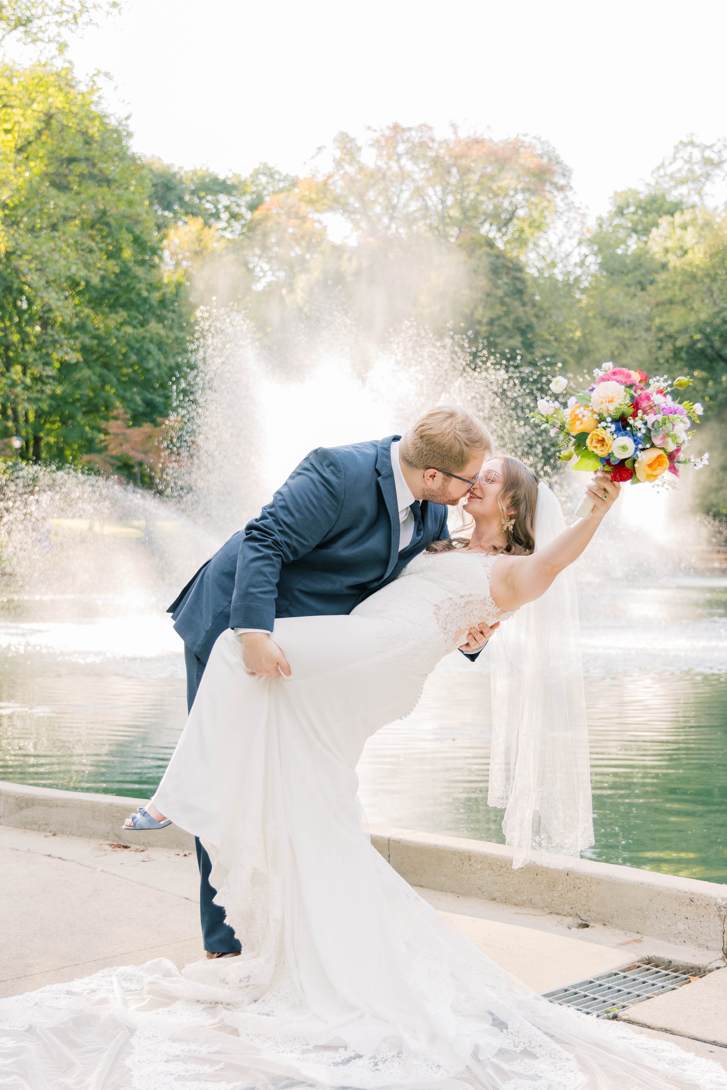 Laurie’s customers, Fernando and Kate embracing by the lake on their wedding day.