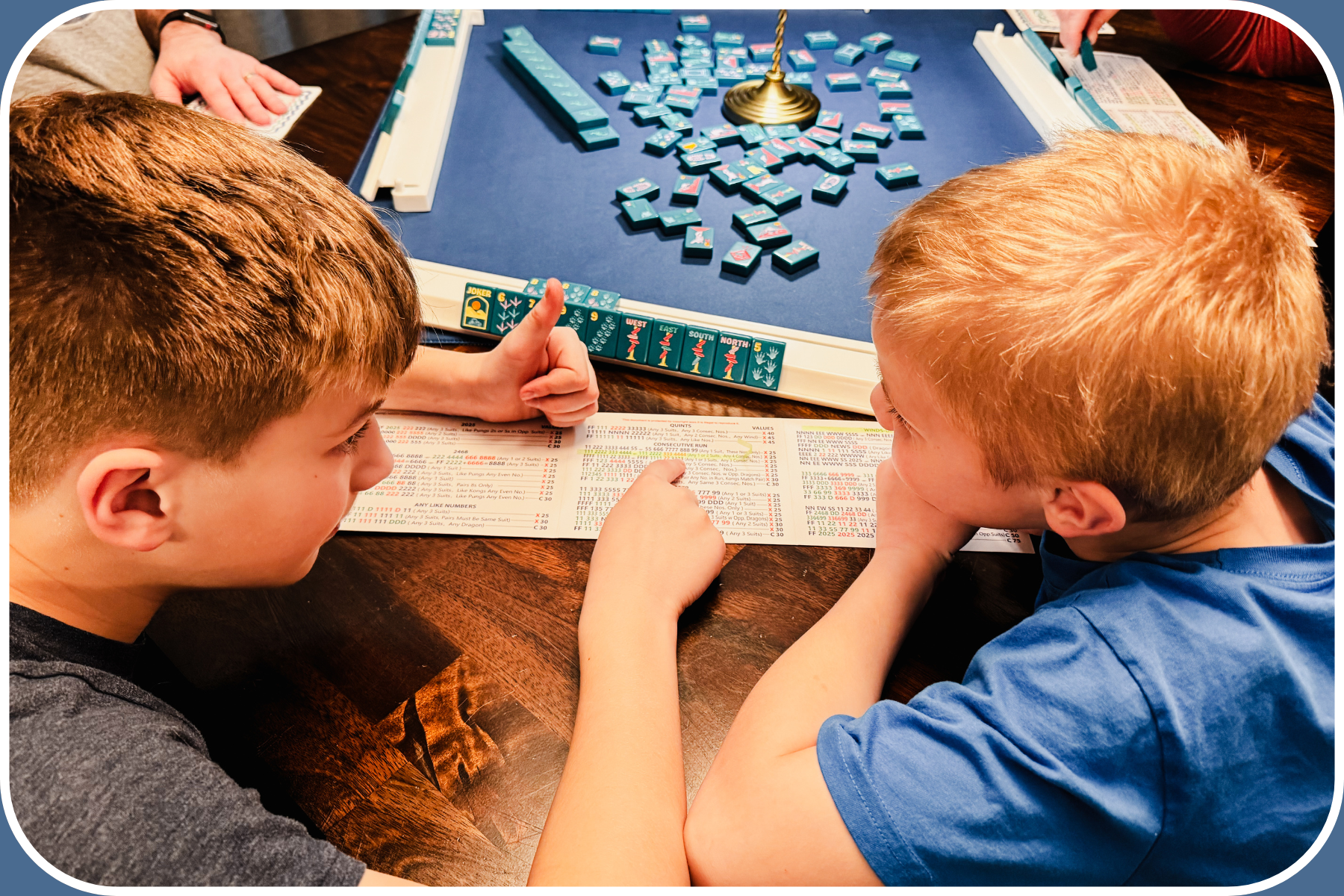 Family lesson with kids playing mahjong