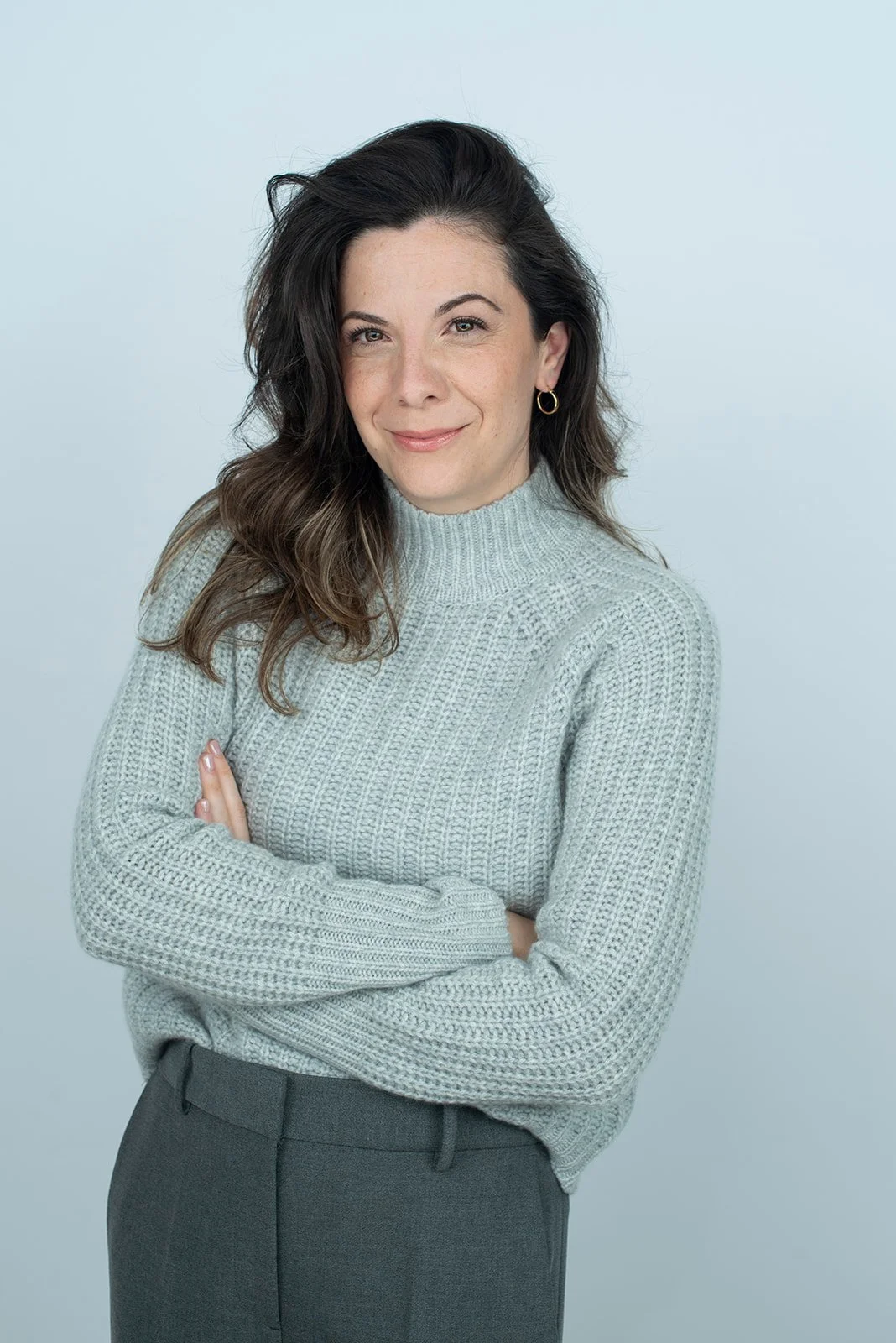 Dr. Tatiana Astray, founder of Mastering Leadership Executive Education, in a light gray knit sweater, a science-led, trust-centred leadership and negotiation specialist.
