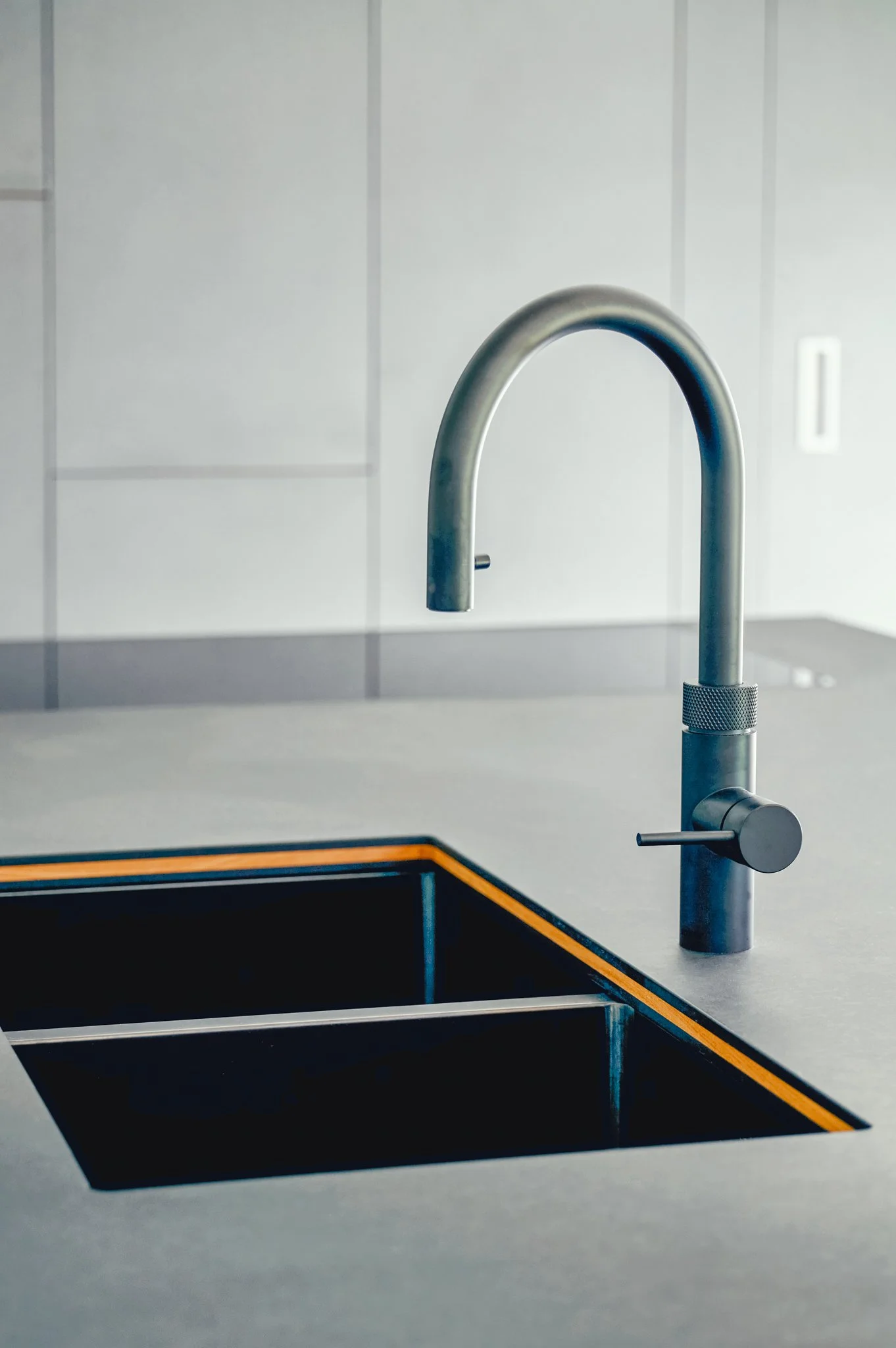 Bespoke elm kitchen with quality worktops and warm timber joinery in a Devon stone barn, Slapton