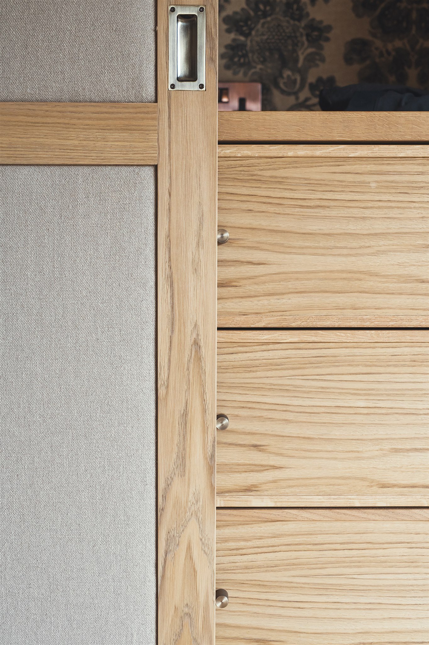 Luxury bespoke master dressing room wardrobes with pivot pocket doors and oak veneer in Dartmouth, Devon