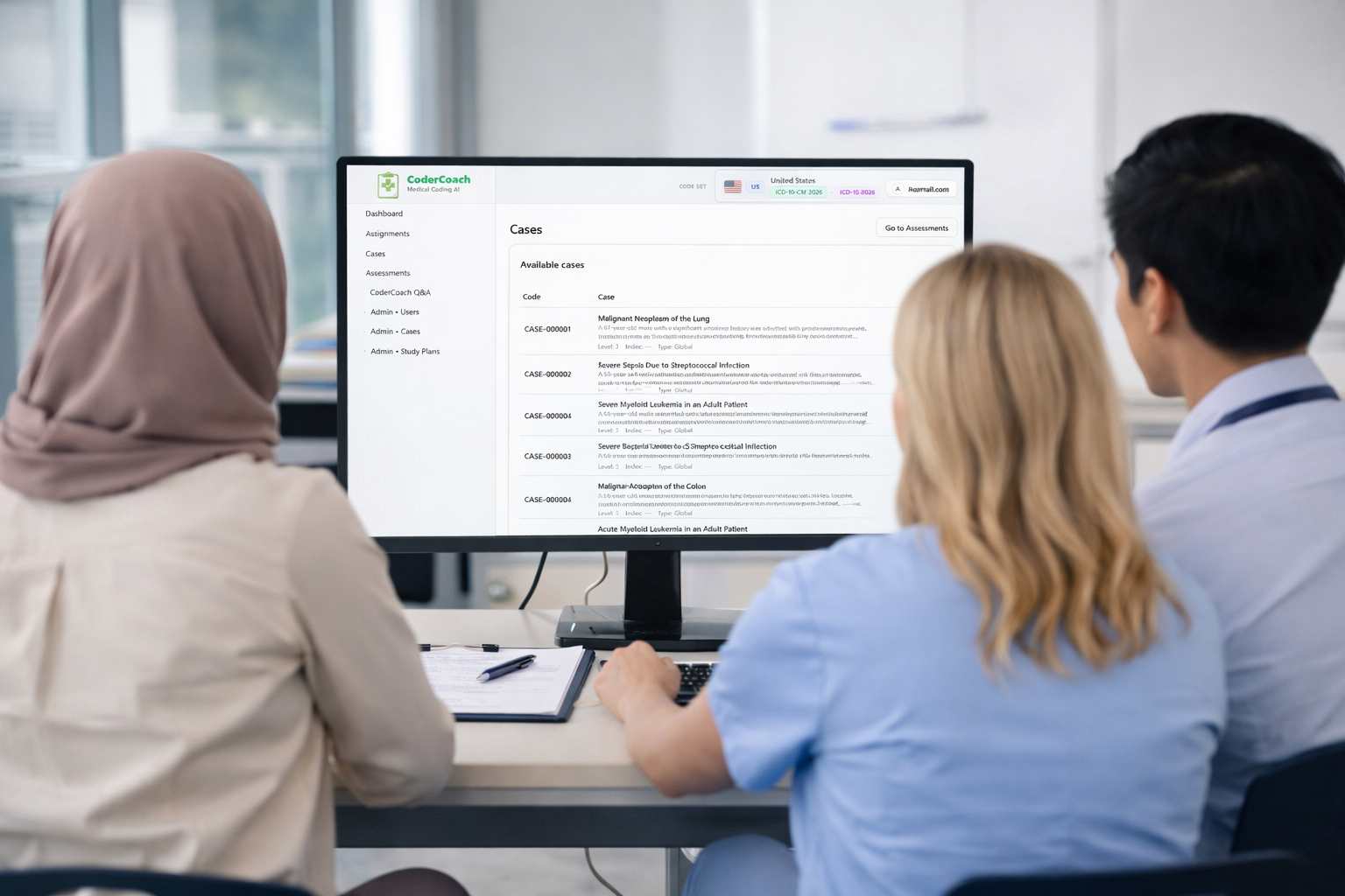 Three medical professionals looking at CoderCoach on a computer screen displaying cases and patient information in a medical office.