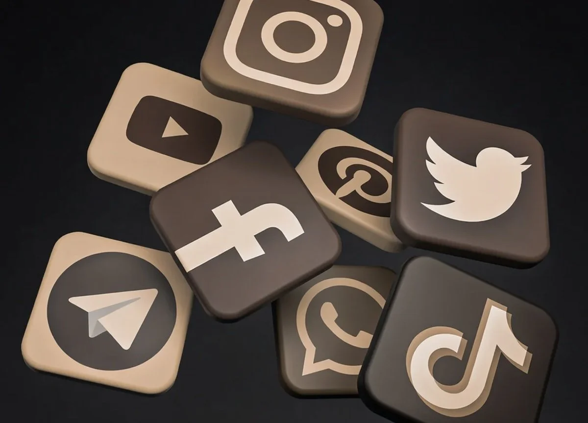 Collection of social media app icons, including Instagram, YouTube, Facebook, Pinterest, Twitter, Telegram, WhatsApp, TikTok, and others, displayed as 3D square tiles on a black background.