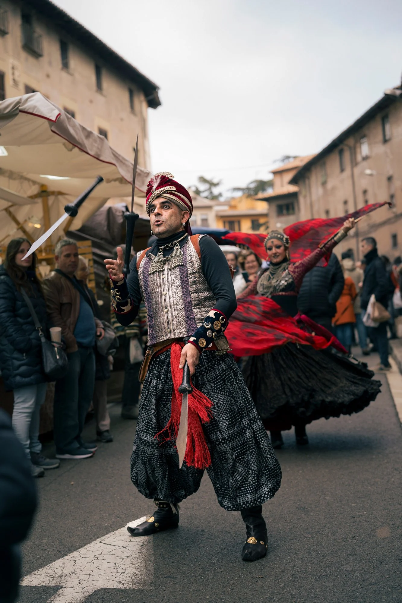 Street performer by La Nariz Roja in costume during a cultural festival, mercat medieval Vic, Spain.