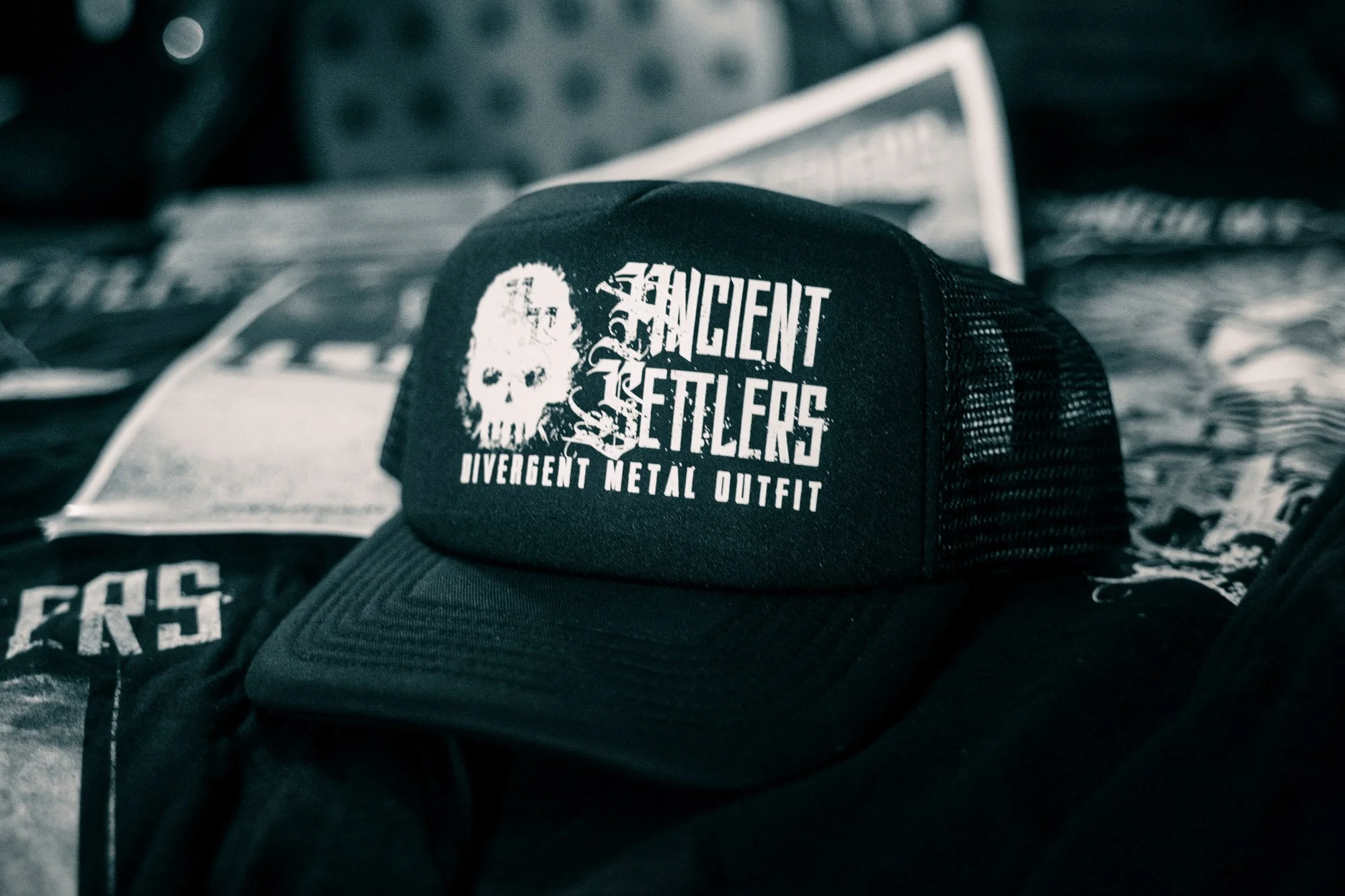 detail of metal festival merchandise cap on display table