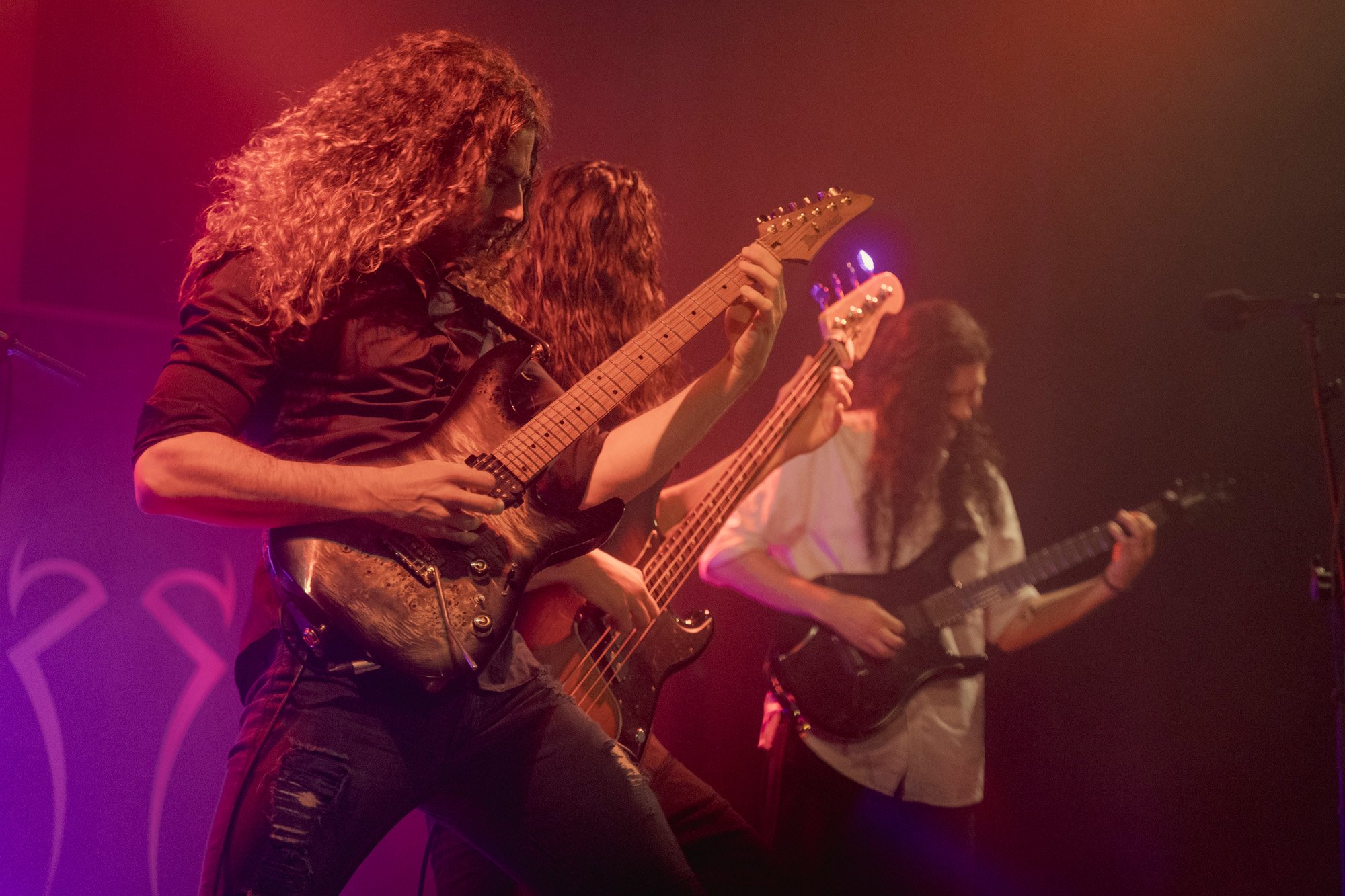 Guitarists performing together on stage during Serapis Project concert.