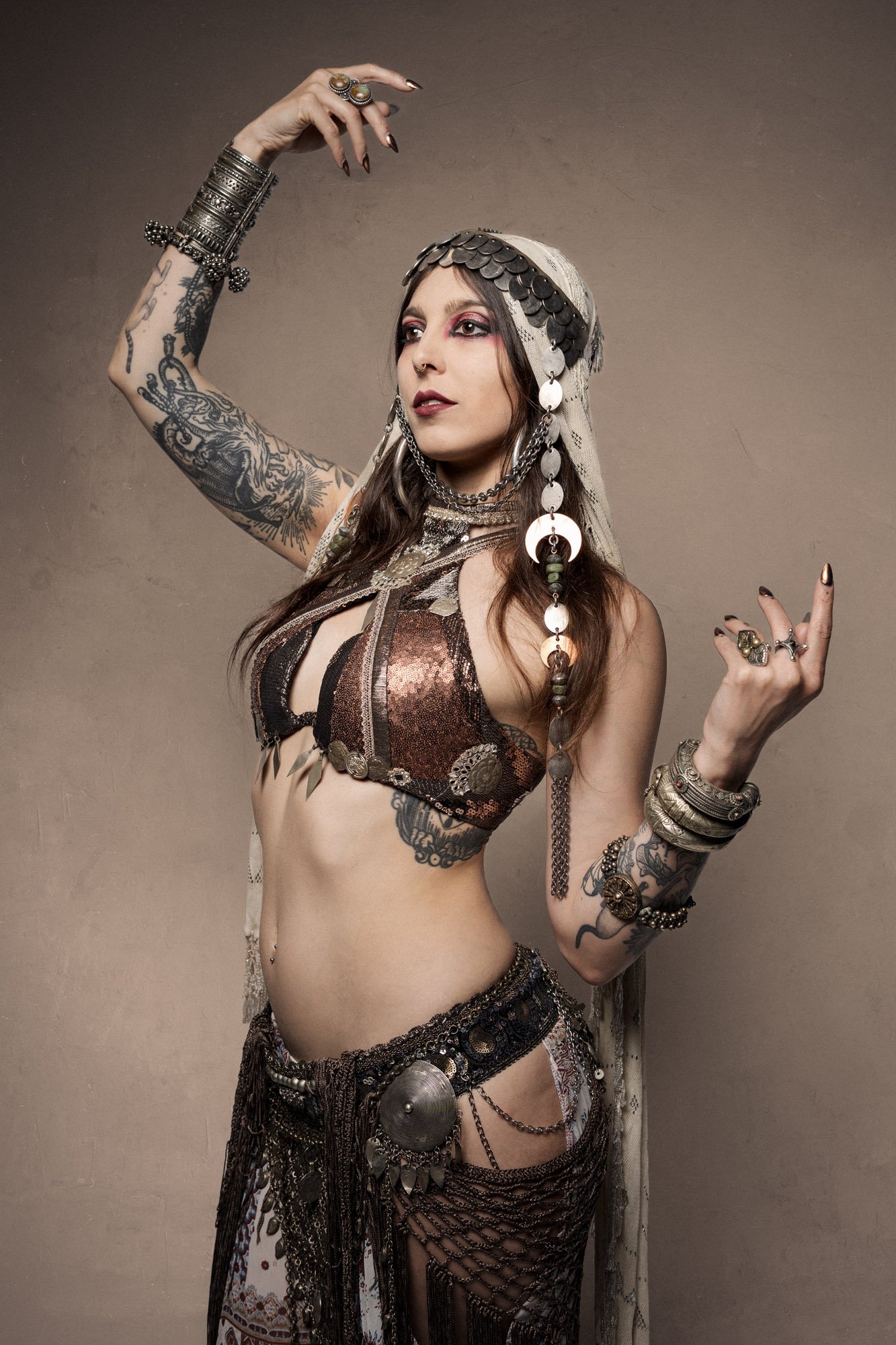Cosmosdaughter posing in layered tribal fusion costume during artistic portrait session