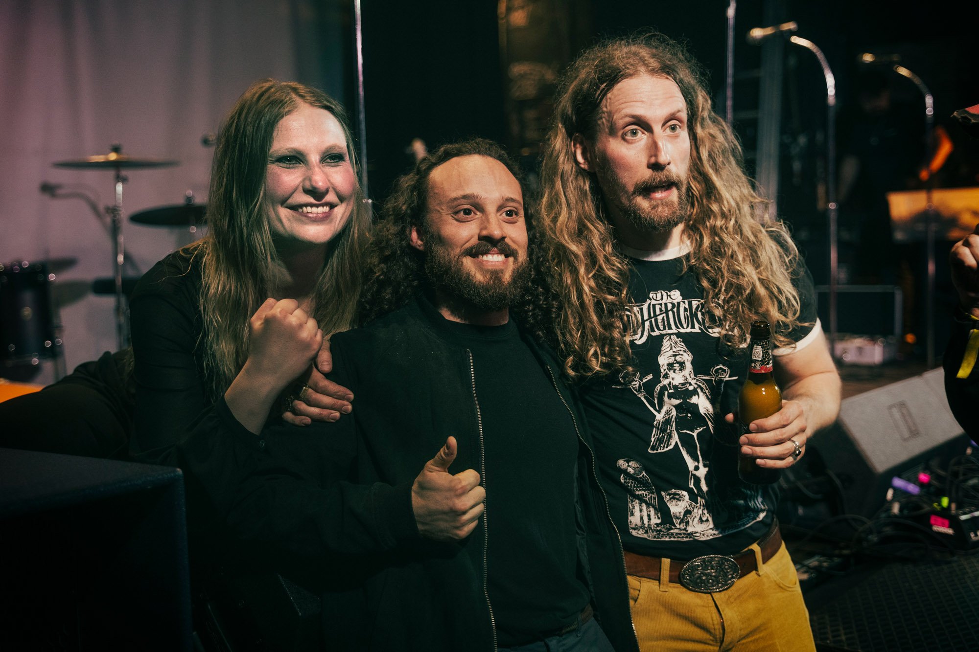 band posing with fans after live performance at concert venue