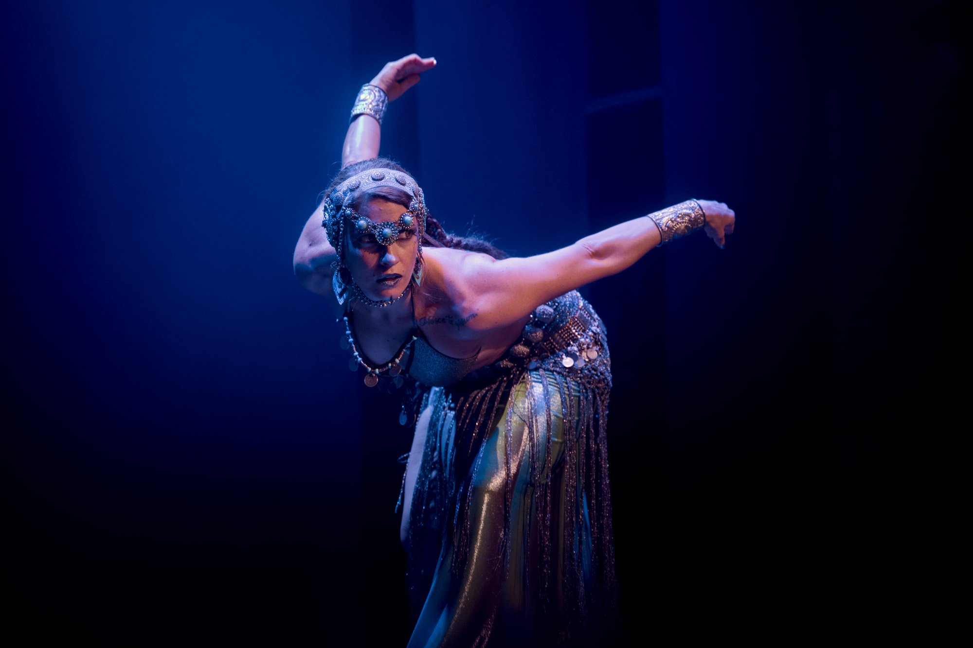Tribal fusion dancer Lidia Martin Lilu performing on stage at a Tribal and Flames dance festival in Barcelona.