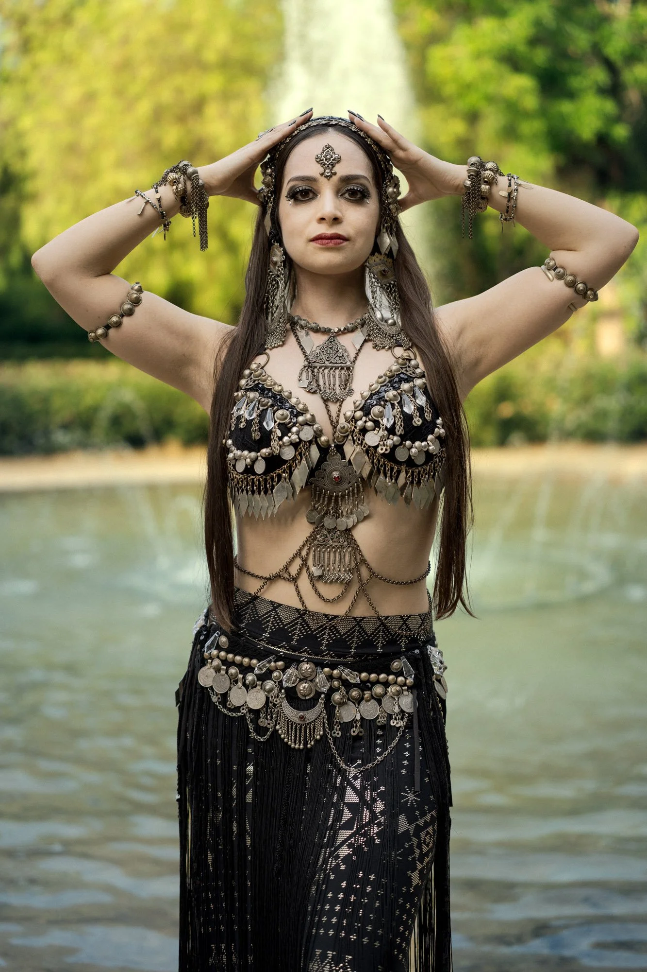 Michelle Bettridge posing with her hands raised during an outdoor tribal fusion portrait session in Barcelona
