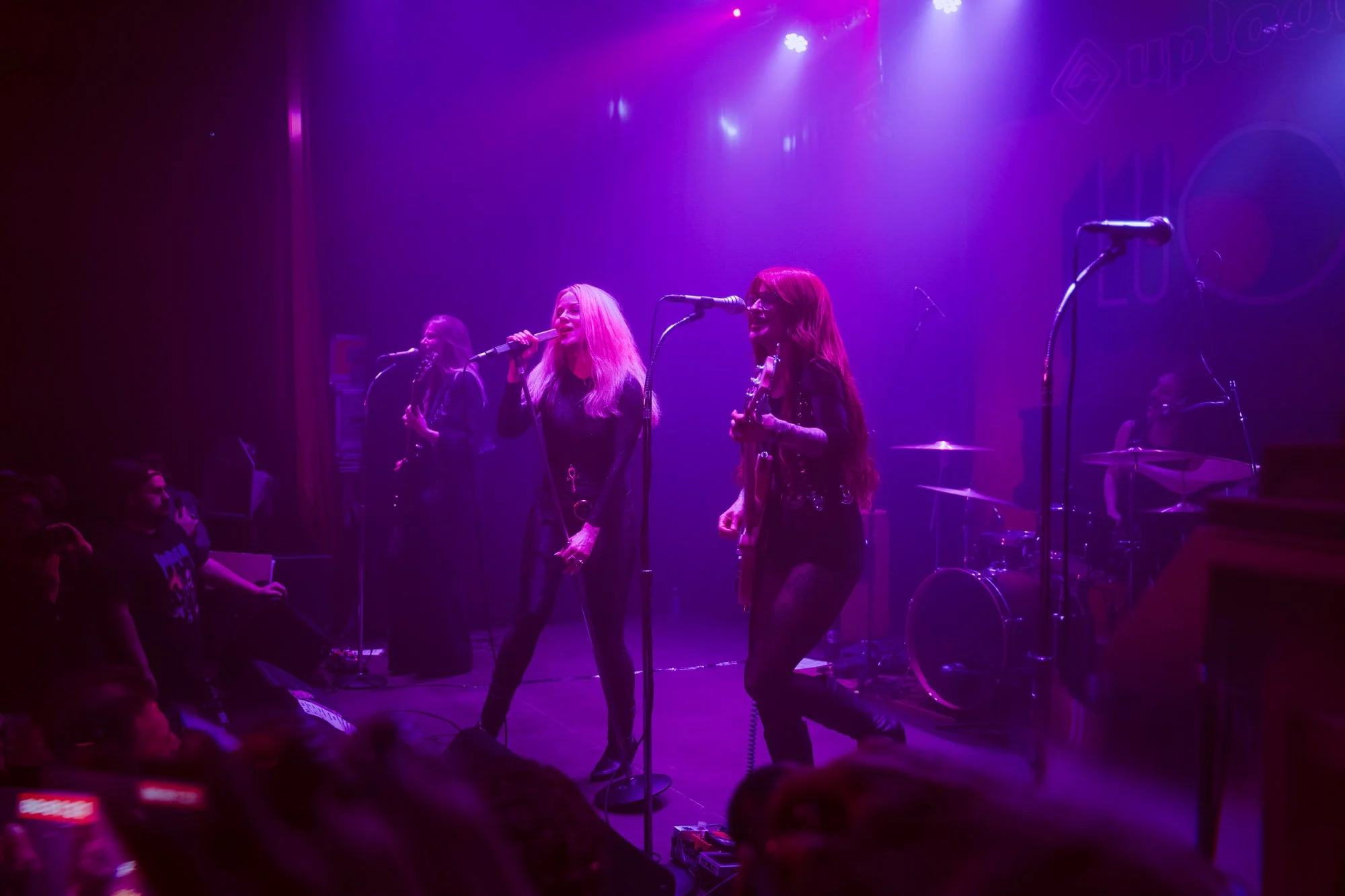 band performing together on stage during live rock concert