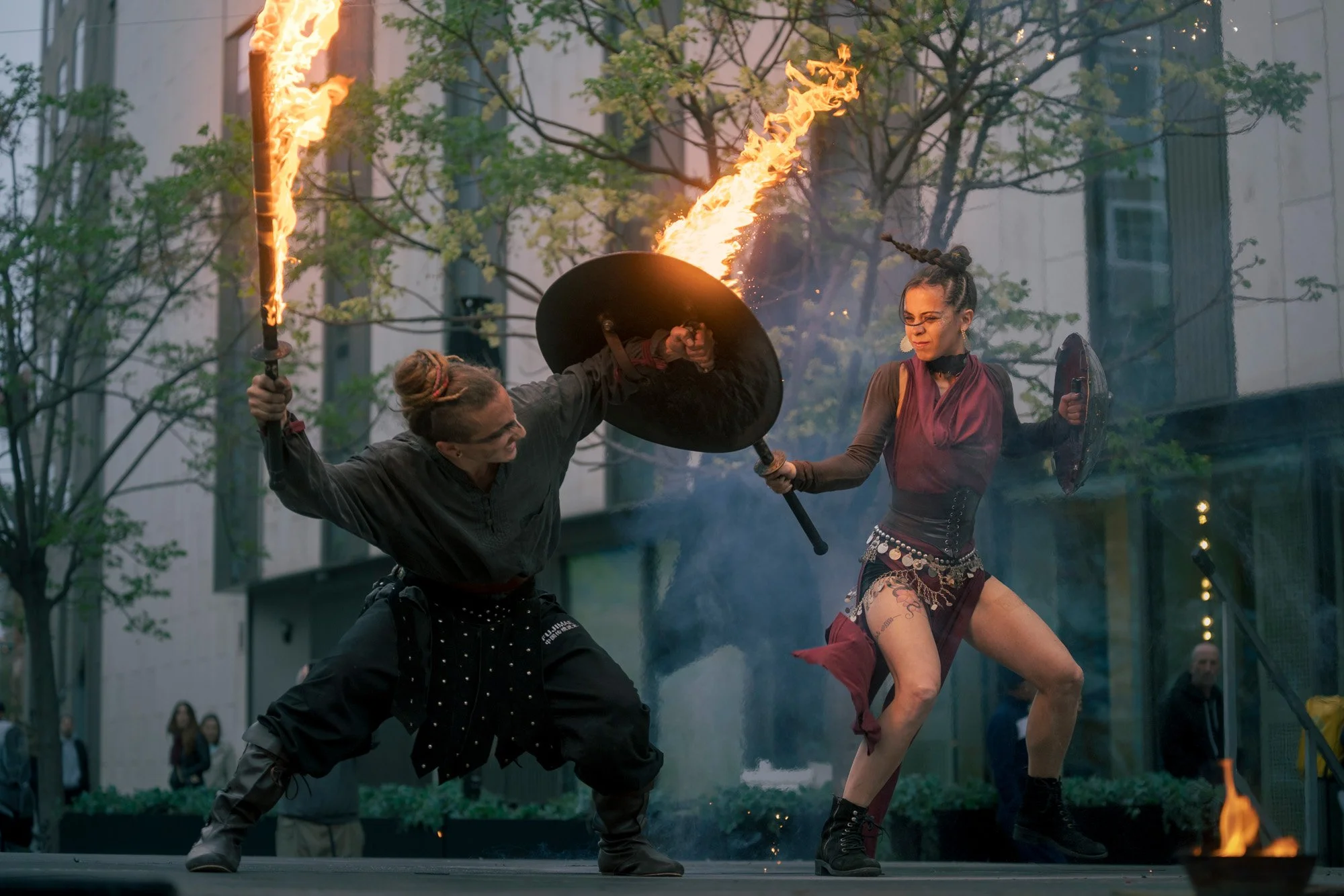 Fire performance by Pendrafoc during a street event, torches and shields in action, Barcelona, Spain.