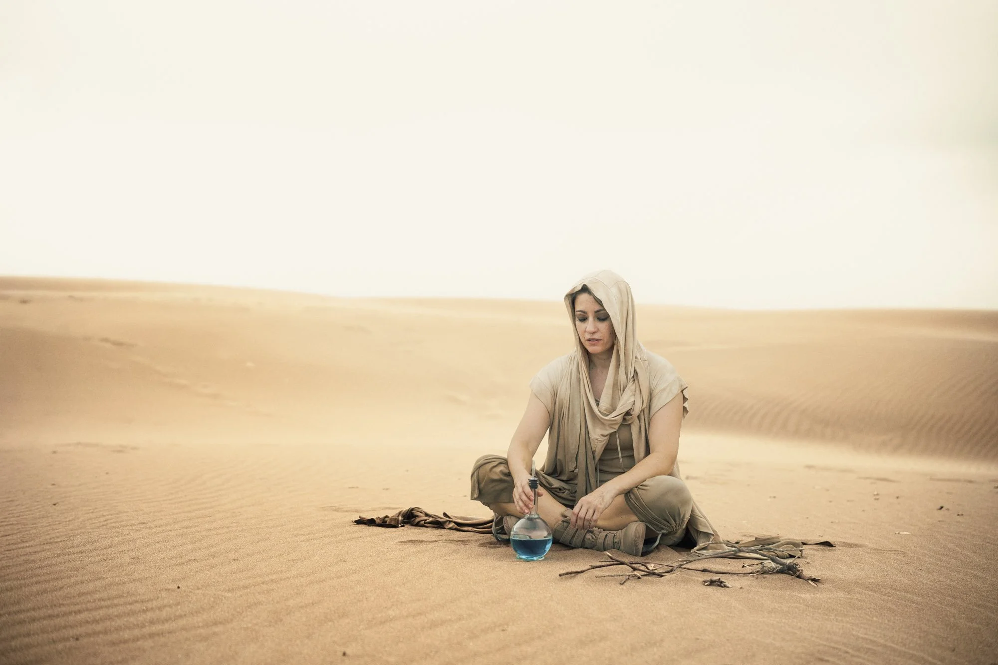 Lidia Martin as a Fremen wanderer sitting in the desert