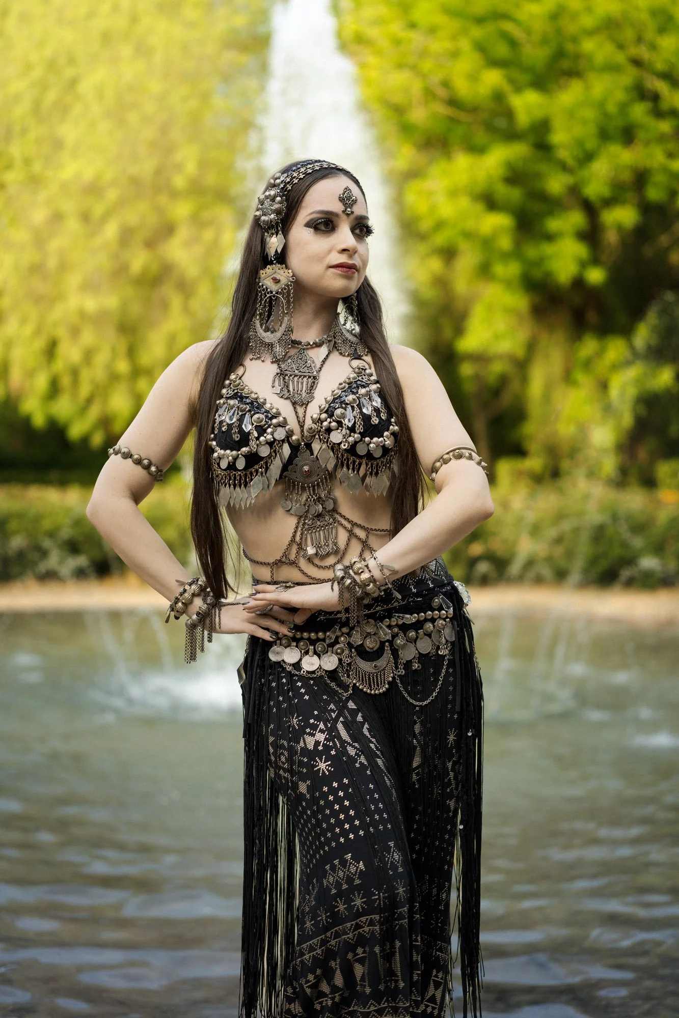 Michelle Bettridge standing in tribal fusion costume beside the fountain at the Jardins de Laribal