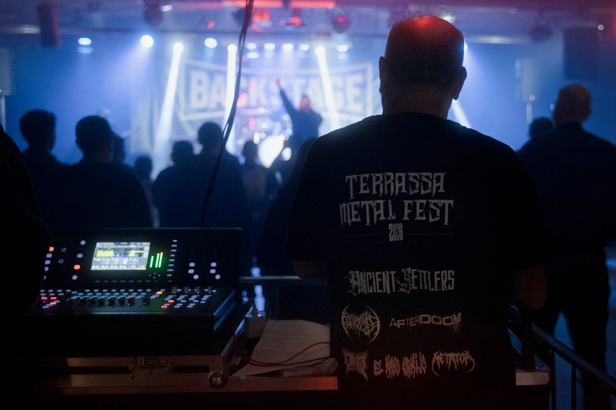 sound technician working at mixing desk during live metal festival in Terrassa
