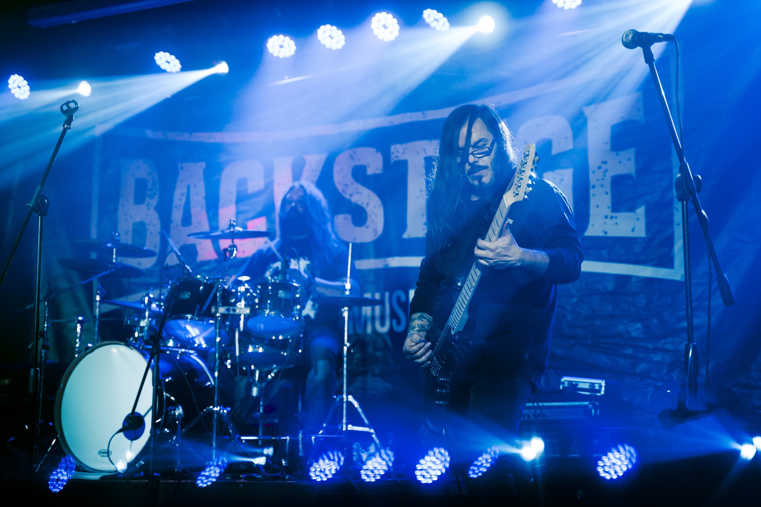 guitarist performing live on stage during metal concert in Terrassa