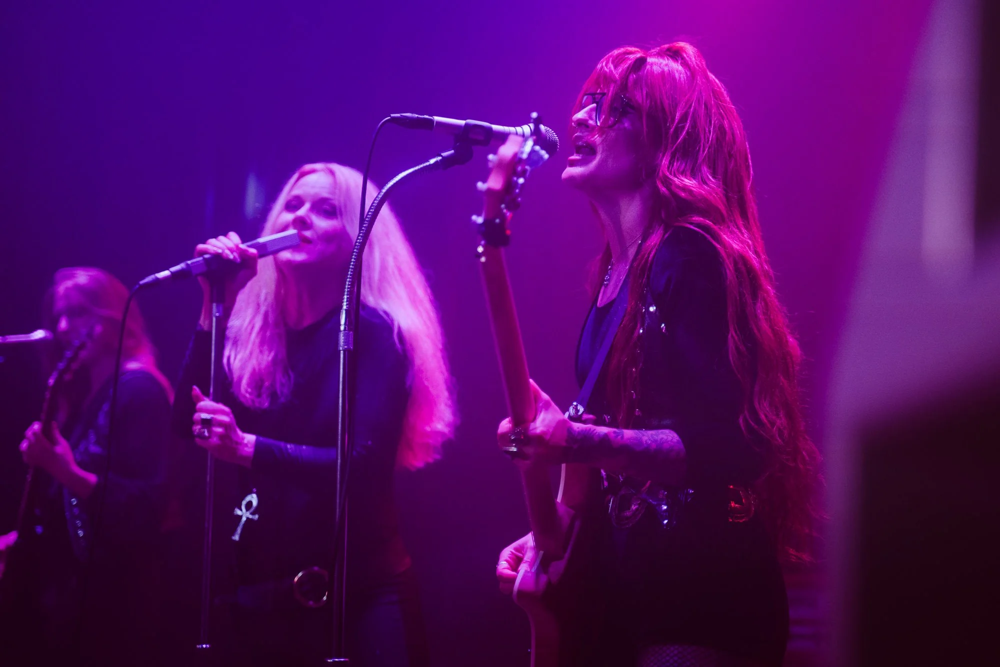 two vocalists singing together on stage during Lucifer concert